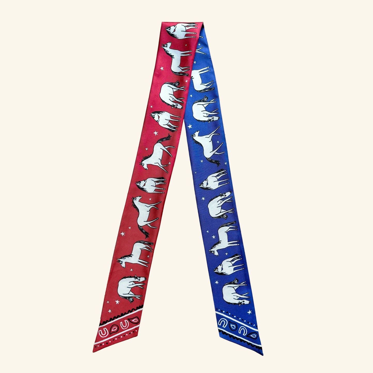 Two-sided silk twilly inspired by the Year of the Horse, featuring red and navy colorways with hand-drawn horses in motion.
