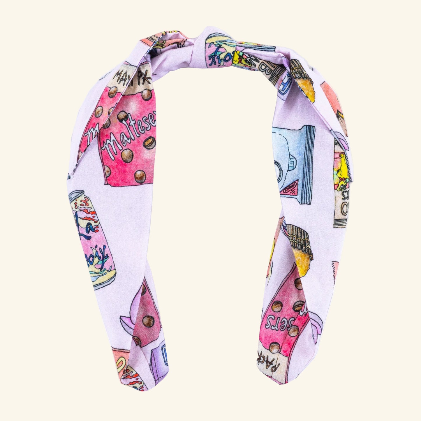 Colorful headband with cartoon-style designs of hand illustrated snacks on a white background