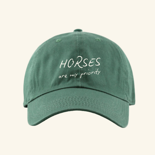 Embroidered dad hat with “Horses Are My Priority” and a horseshoe. A casual equestrian staple for horse girls.