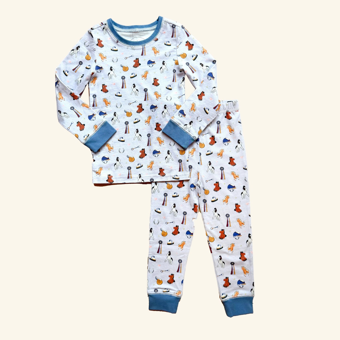 Organic cotton kids pajamas in sizes 2T–10T featuring a hand-illustrated Year of the Horse print. Designed for tiny horse girls.