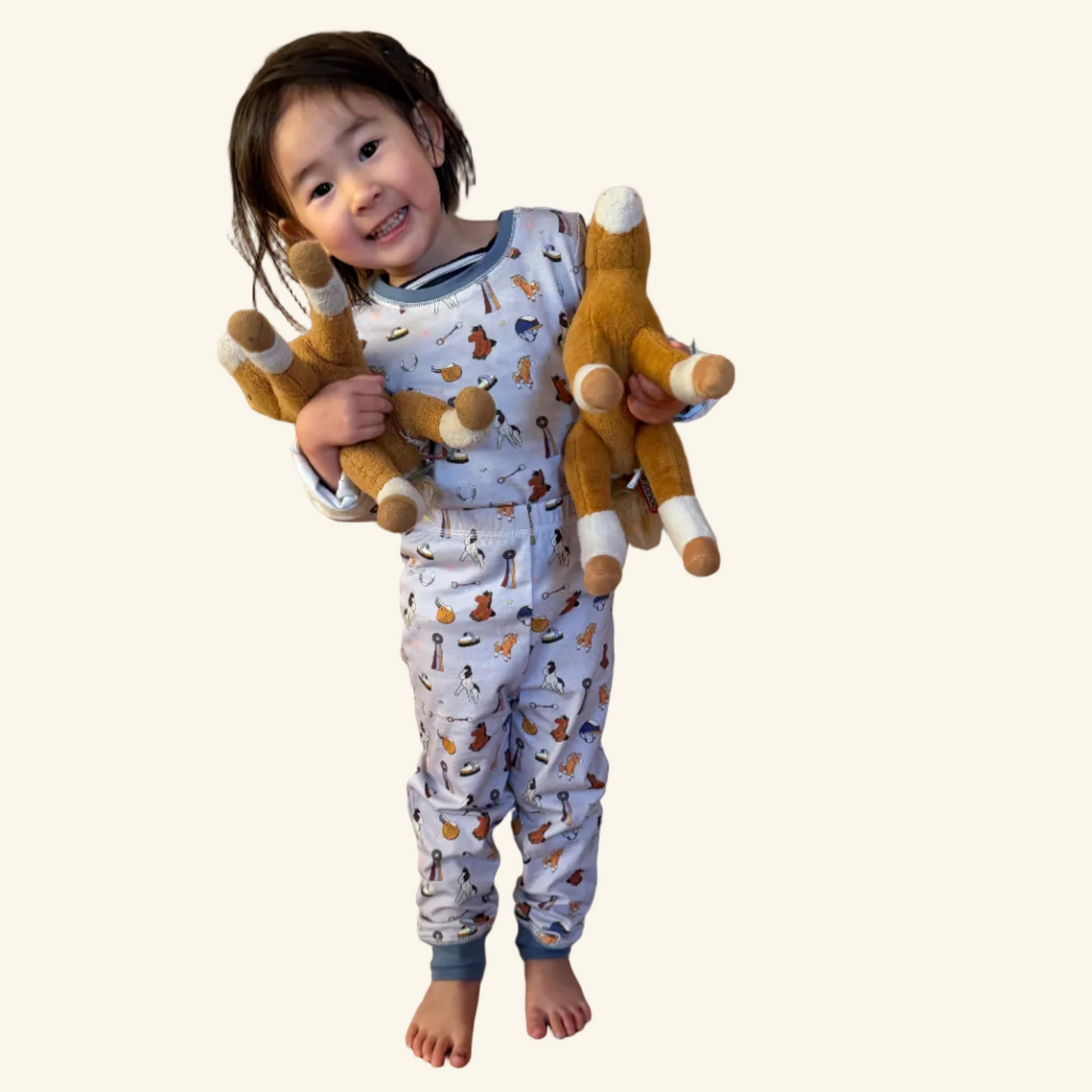 Organic cotton kids pajamas in sizes 2T–10T featuring a hand-illustrated Year of the Horse print. Designed for tiny horse girls.